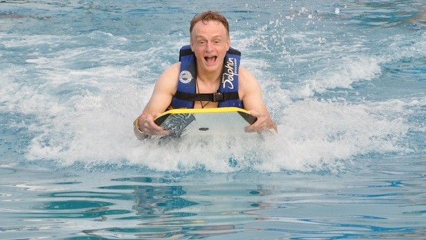 Foot push with boogie board, during Royal Dolphin Swim at Dolphin Discovery.