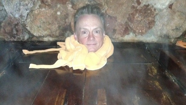 Sitting inside a steam box bath at Piedra de Agua, in Cuenca.