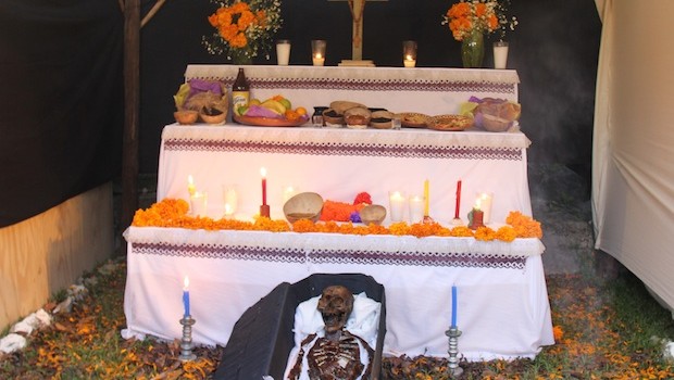Religious icons and skeletons are part of the Day of the Dead altars.