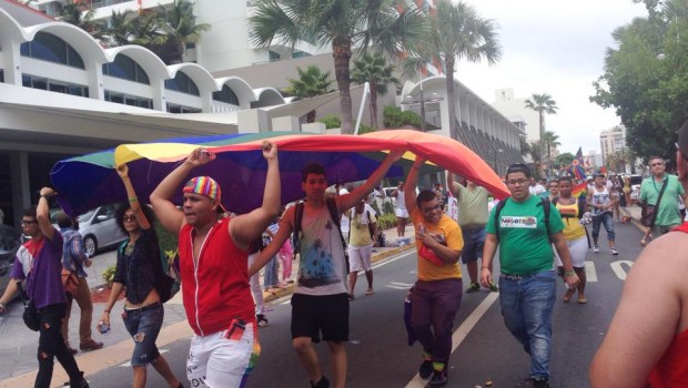 Marchers carry a gay pride flag in San Juan, Puerto Rico.