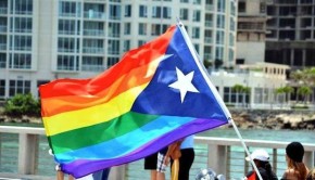 A gay pridel hybrid of a rainbow flag and Puerto Rican flag.