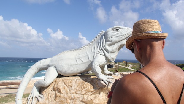 Angel bravely approaches the giant iguana for a photo.